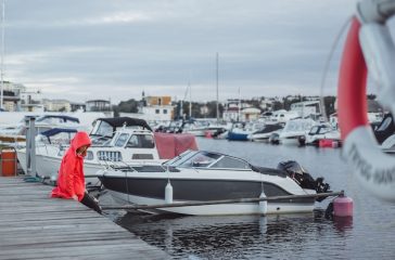 beautiful-young-woman-red-cloak-yacht-port-stockholm-sweden_72229-342