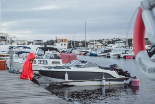 beautiful-young-woman-red-cloak-yacht-port-stockholm-sweden_72229-342